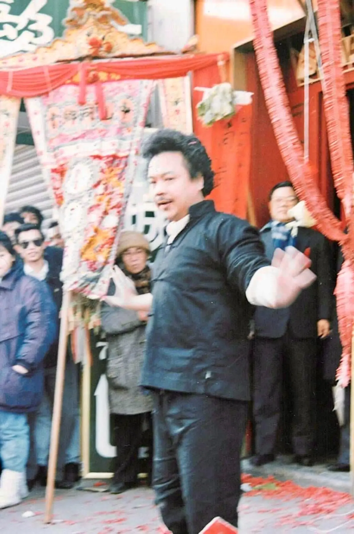 Sifu Tony Lau demonstrating an open-palm movement before a Chinatown crowd